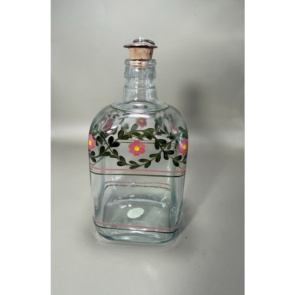 A Casafina Portugal hand-painted decanter featuring pink flowers and green vines